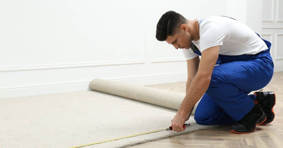 Carpet installer measuring a room in Conyers GA