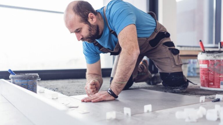Professional tile installer laying floor tiles with precision during tile installation in Conyers GA and Atlanta GA homes.